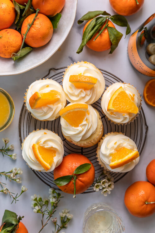 Today I'm teaching you how to make Mimosa Cupcakes! Light and fluffy, these delicious cupcakes are made with freshly squeezed orange juice, orange zest, and of course, CHAMPAGNE! One of my favorite cupcake recipes for brunch or special occasions like Easter, Mother's Day, or New Year's Eve!