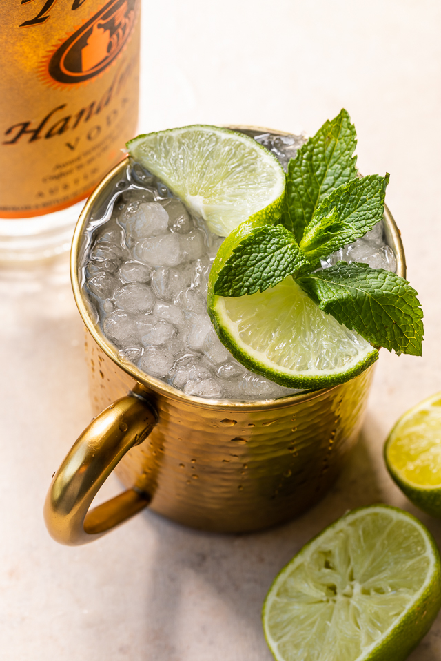 The Best Moscow Mule Recipe features spicy ginger beer, fresh lime juice, vodka, and a ginger lime simple syrup! On a hot Summer day, this refreshing cocktail really hits the spot! For an extra pretty presentation, serve in a copper mug with a sprig of mint and a lime wedge or spiral!