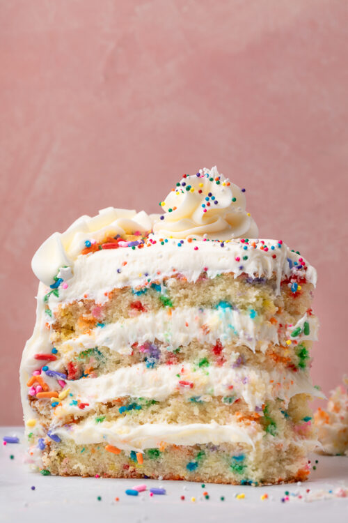 Featuring light and fluffy cake layers that are exploding with rainbow sprinkles and slathered in a silky smooth cream cheese buttercream frosting, this is the Ultimate Funfetti Birthday Cake Recipe!!! Perfect for any special celebration or birthday party! This cake is sure to bring a smile to your face!