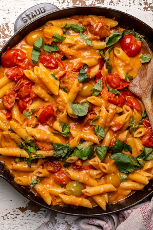 Fresh Tomato Basil Penne alla Vodka is rich, creamy, and so flavorful! The vodka sauce is made with olive oil, a bounty of fresh cherry tomatoes, plenty of garlic, and just a touch of crushed red pepper flakes - plus vodka, cream, and tons of fresh basil! This restaurant quality penne alla vodka recipe is sure to become a family favorite!