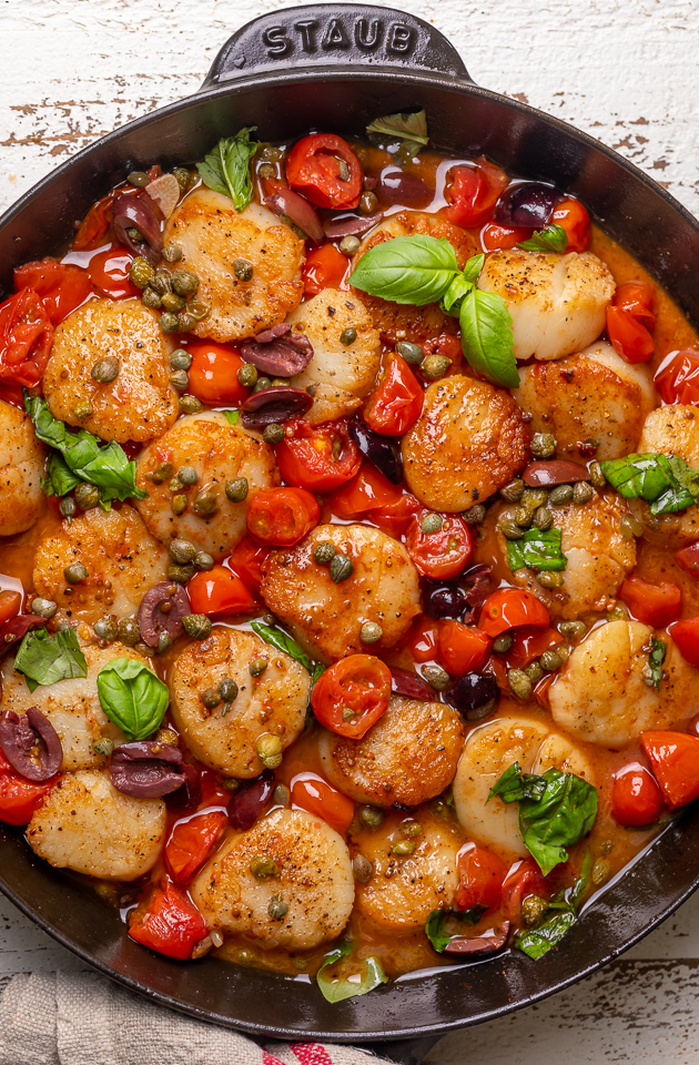 Looking for an easy and flavorful seafood dish? Look no further than these Pan Seared Scallops with Tomatoes, Olives, and Capers! Delicious on their own but insanely good over pasta or a bed of asparagus!