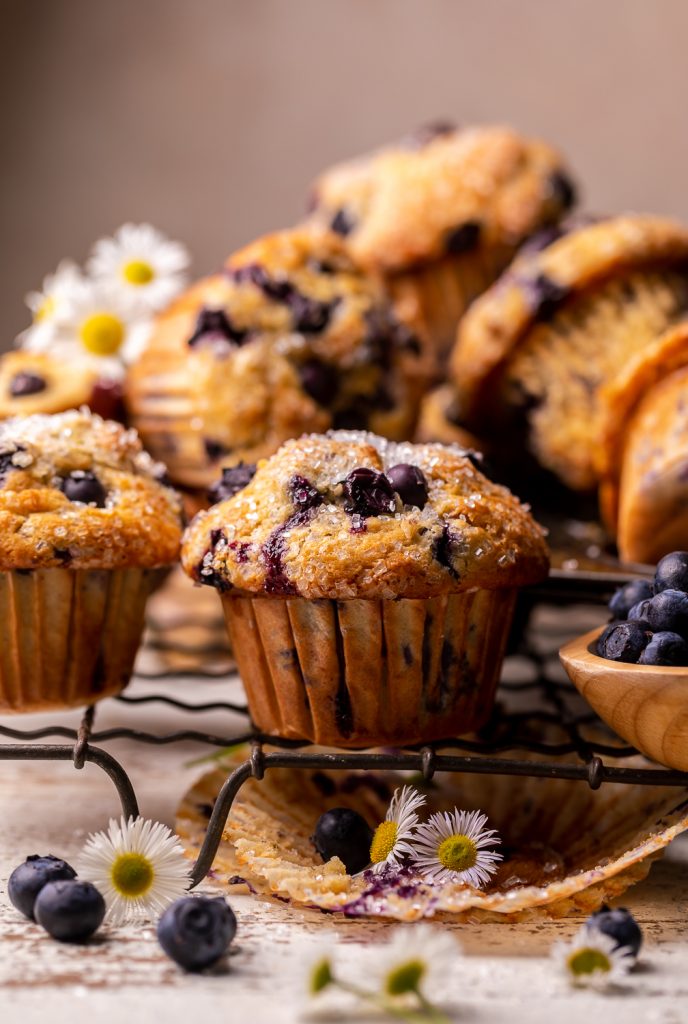 Banana blueberry muffins on a wire rack.