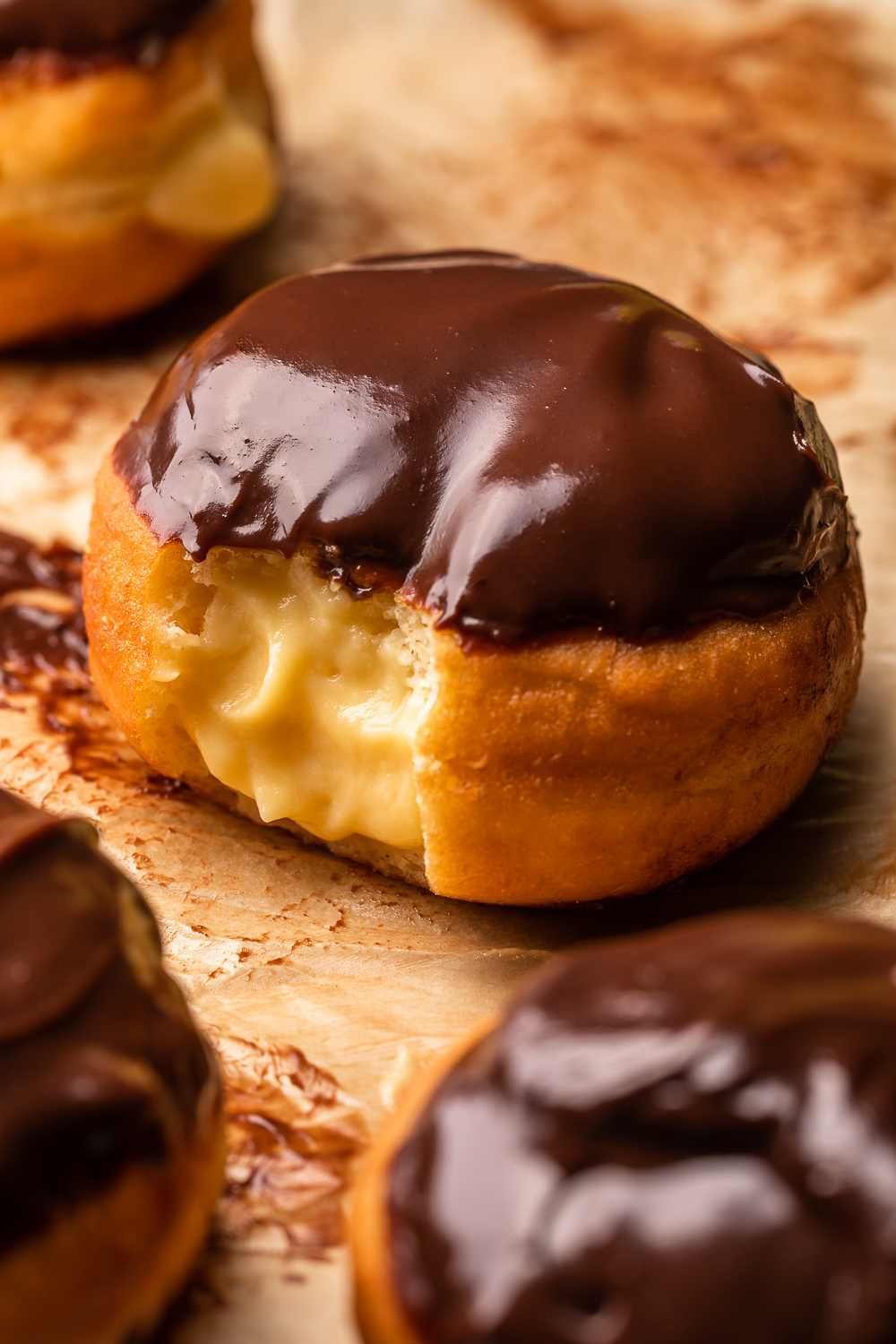 Fluffy Boston Cream Donuts are stuffed with pastry cream filling and dipped in a rich chocolate glaze! Don't let the deep frying scare you off, because this recipe is worth every step. And so much better than anything you'll get from the donut shop.