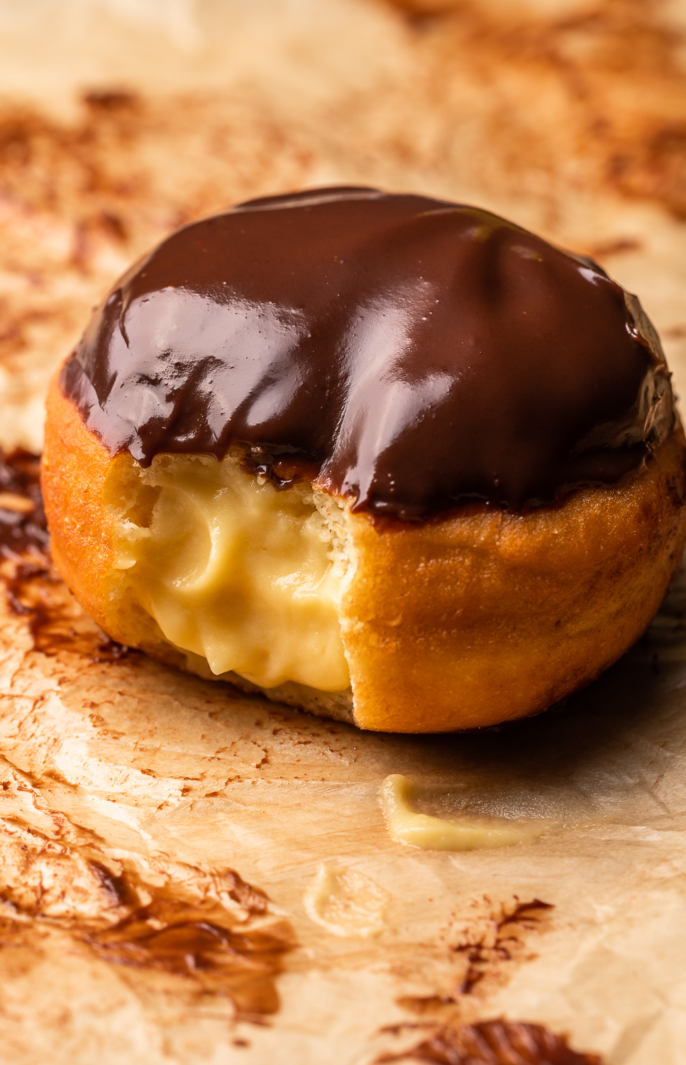 Fluffy Boston Cream Donuts are stuffed with pastry cream filling and dipped in a rich chocolate glaze! Don't let the deep frying scare you off, because this recipe is worth every step. And so much better than anything you'll get from the donut shop.