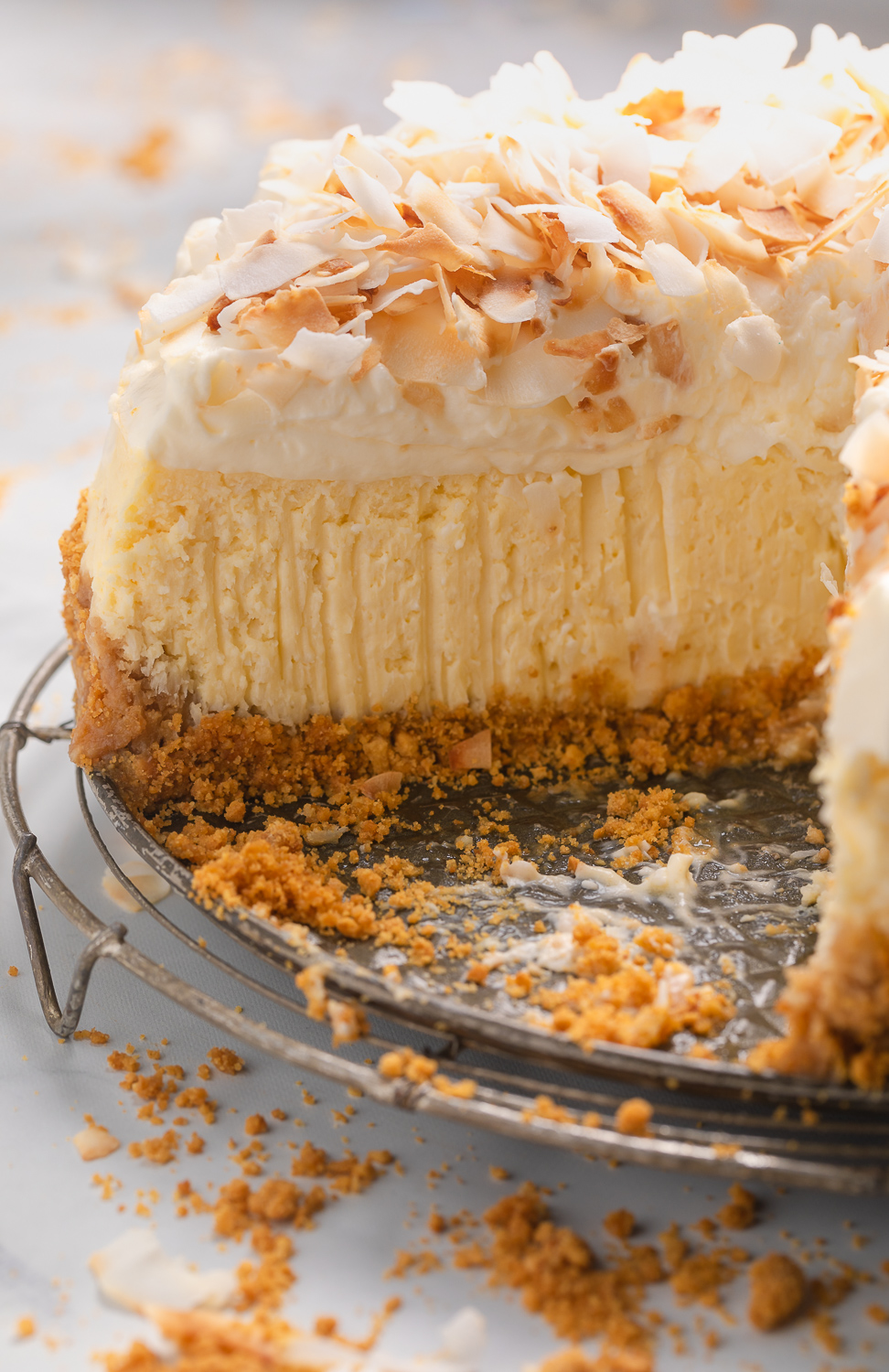 This Creamy Coconut Cheesecake is made with coconut milk, coconut extract, and shredded coconut, so you know it's loaded with refreshing coconut flavor! The crunchy graham cracker crust is the perfect contrast to the creamy filling and fluffy whipped cream topping. A must try for coconut lovers!