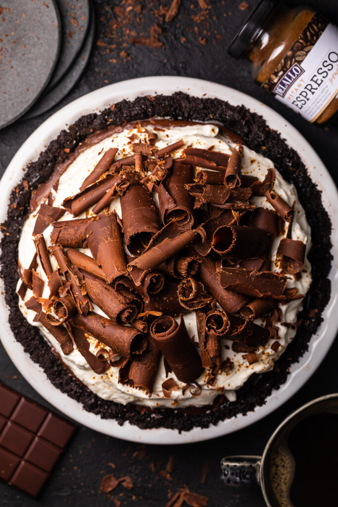 Chocolate pie in a pie plate with chocolate shavings on top. 