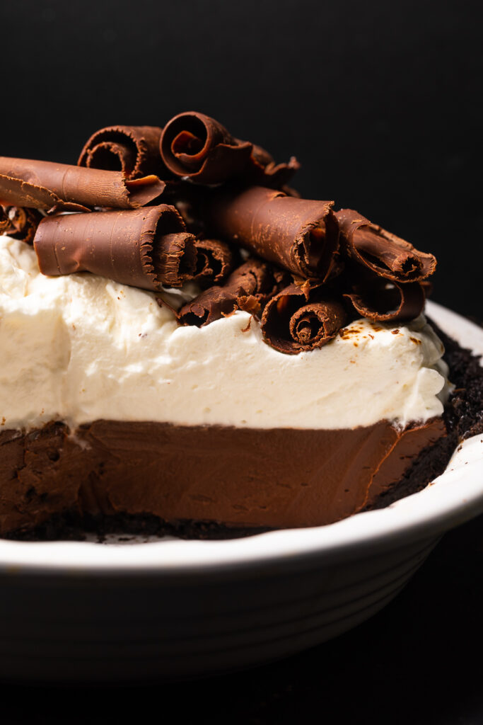 Chocolate pudding pie sliced but still in pie plate. 