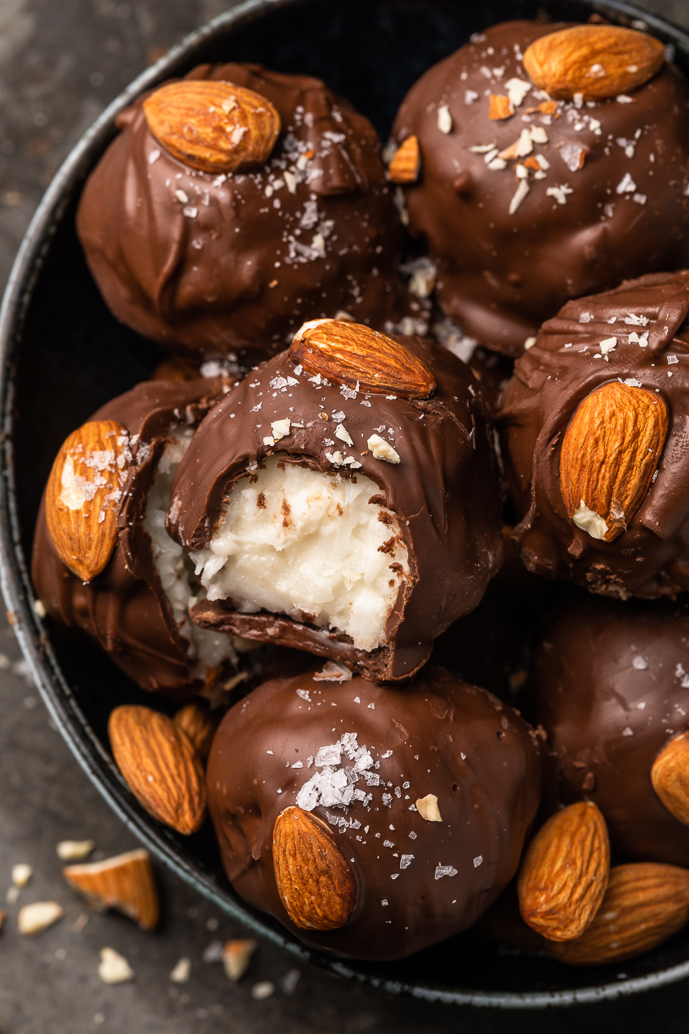 If you like almond joy candy bars, you'll love these almond joy truffles! The coconut mixture is so creamy, it almost tastes like cheesecake, and the rich robe of milk chocolate makes them so decadent! But feel free to dip in dark chocolate for a less sweet treat!