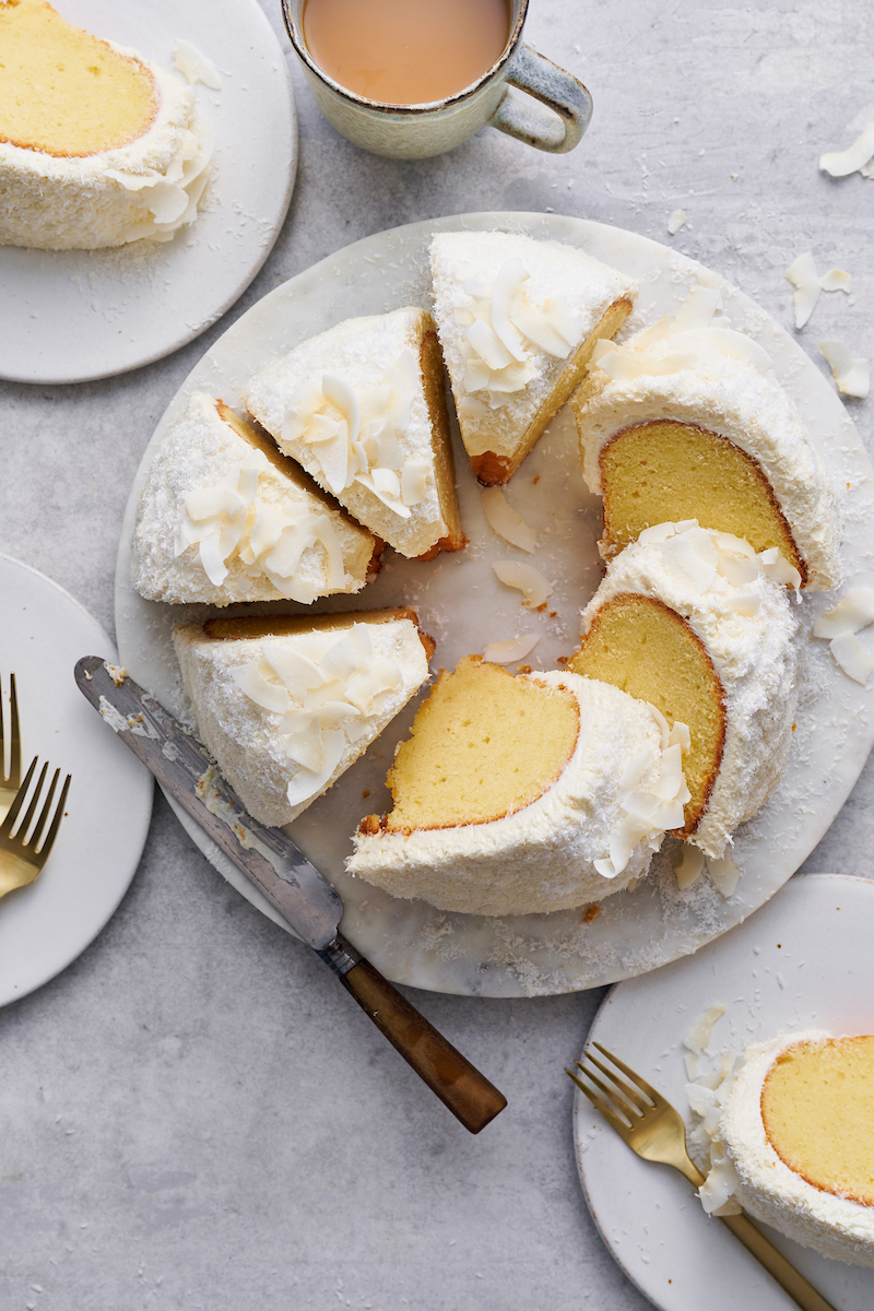 Coconut lovers go crazy over this stunning white chocolate coconut pound cake! Baked in a bundt pan, this cake is covered in sweet white chocolate frosting, shredded coconut, and flaked coconut. Dense yet light and fluffy, with plenty of coconut flavor!