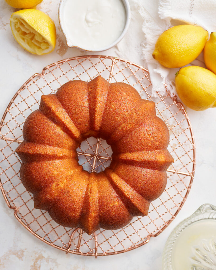 Lemon Bundt Cake on gold wire cooling rack.