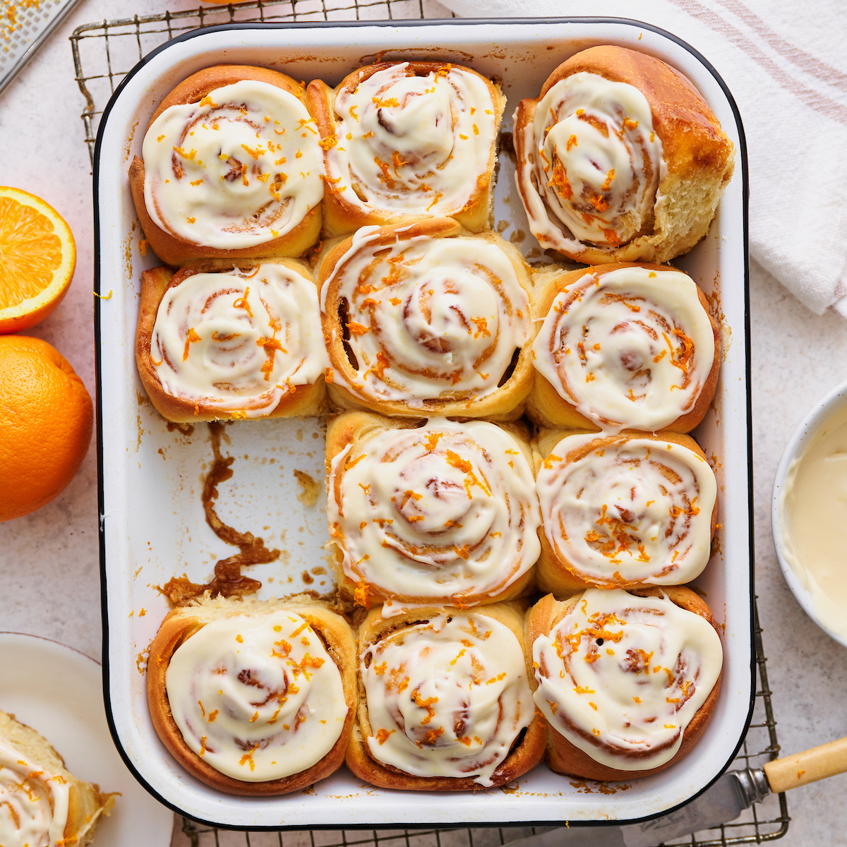 Soft and fluffy orange rolls are loaded with fresh orange flavor and slathered in cream cheese frosting! This special breakfast treat is a Christmas morning tradition in our house... but they're so good we've started making them for Easter, Mother's Day and sometimes, just because! Serve warm, straight from the baking dish!