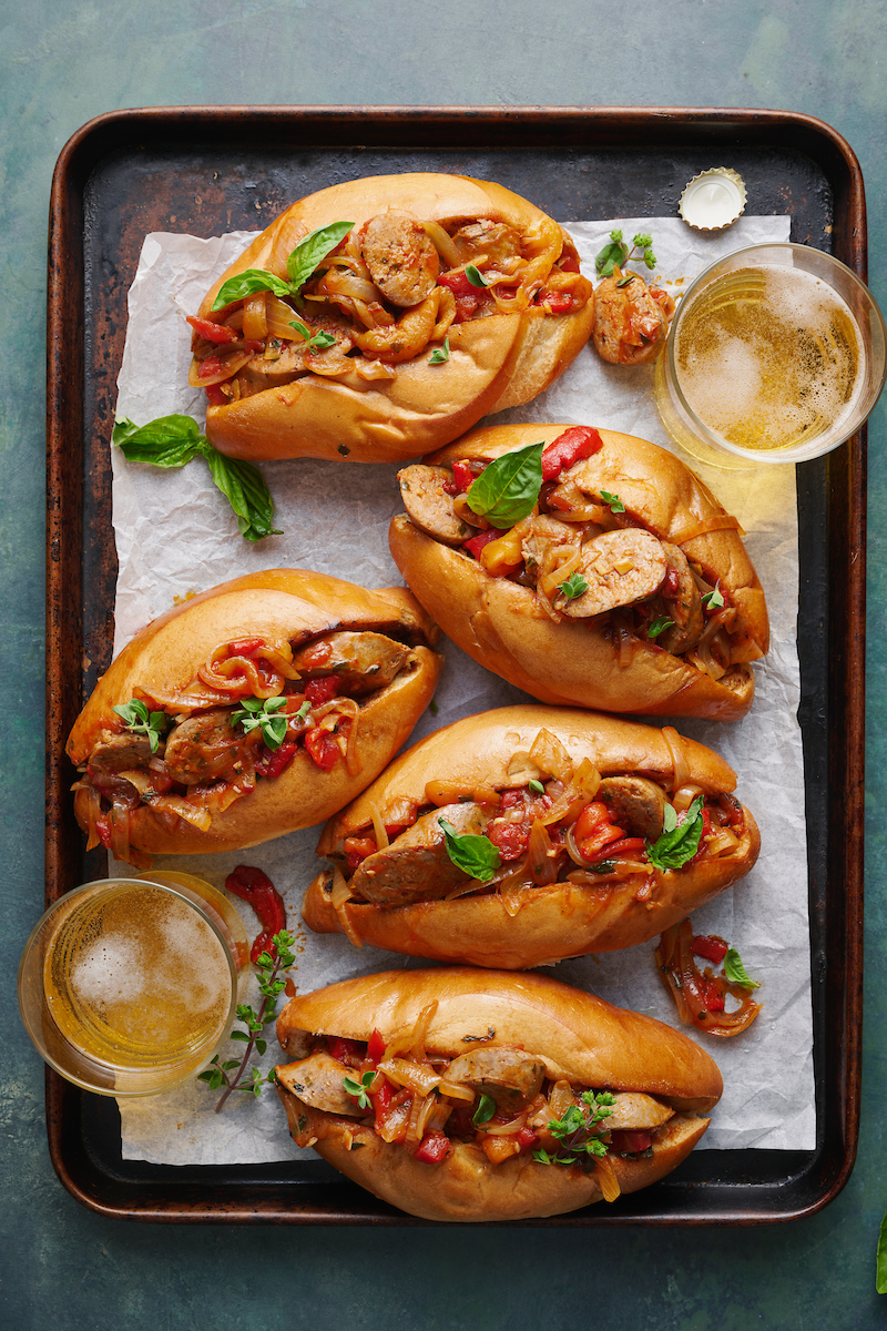 Italian Sausage and Peppers is delicious served with pasta or piled high on a chewy hoagie roll! Loaded with sausage, peppers, and onions and coated in a tangy tomato sauce, this is one of my favorite recipes to make for company! Serves a crowd and can be kept warm in a crockpot or slow cooker.