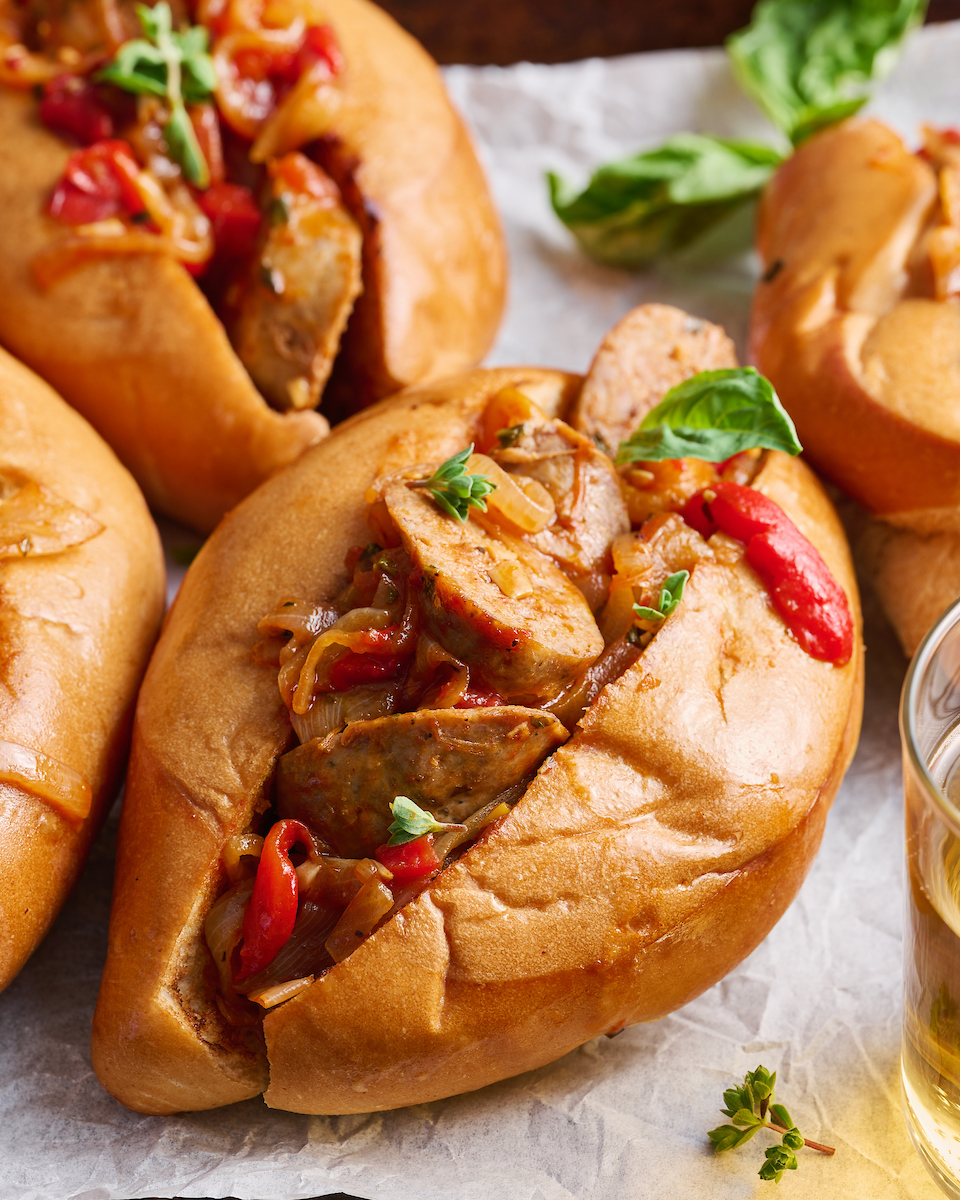 Italian Sausage and Peppers is delicious served with pasta or piled high on a chewy hoagie roll! Loaded with sausage, peppers, and onions and coated in a tangy tomato sauce, this is one of my favorite recipes to make for company! Serves a crowd and can be kept warm in a crockpot or slow cooker.