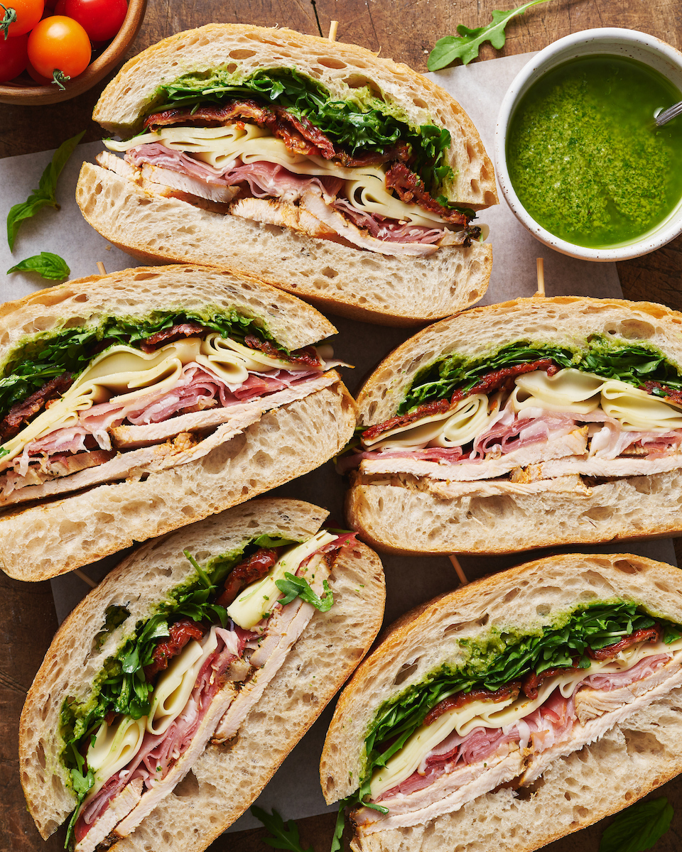 This crowd-pleasing Italian Turkey Club Sandwich is perfect for picnics, parties, or those nights it's just too hot to cook! Loaded with sliced turkey, prosciutto, arugula, sun-dried tomatoes, and a homemade Italian dressing, this recipe is so flavorful and fresh. So without further ado, let's make sandwiches!