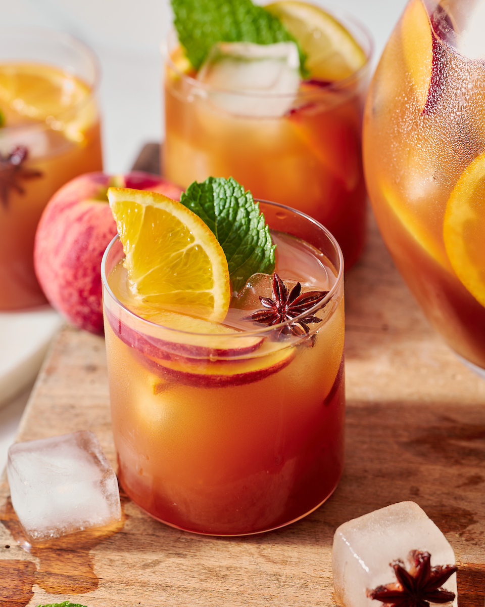 If you're searching for a big batch summer cocktail, look no further than this bourbon spiked peach iced tea! Made with peach nectar, black tea, and fresh peach slices, this recipe is perfect for barbecues, parties, and picnics. Bust out a large pitcher and make a batch today!