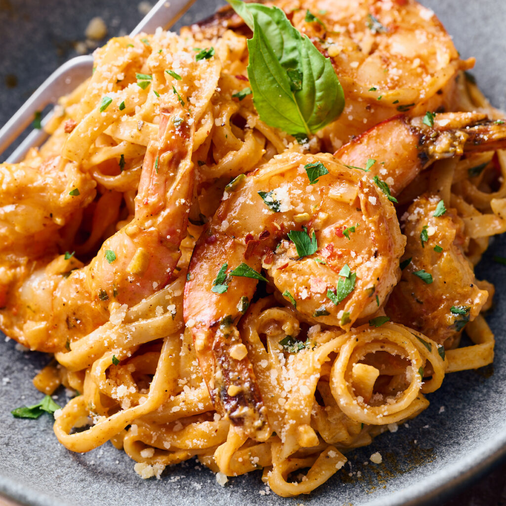 Bowl of cajun shrimp pasta with fork.