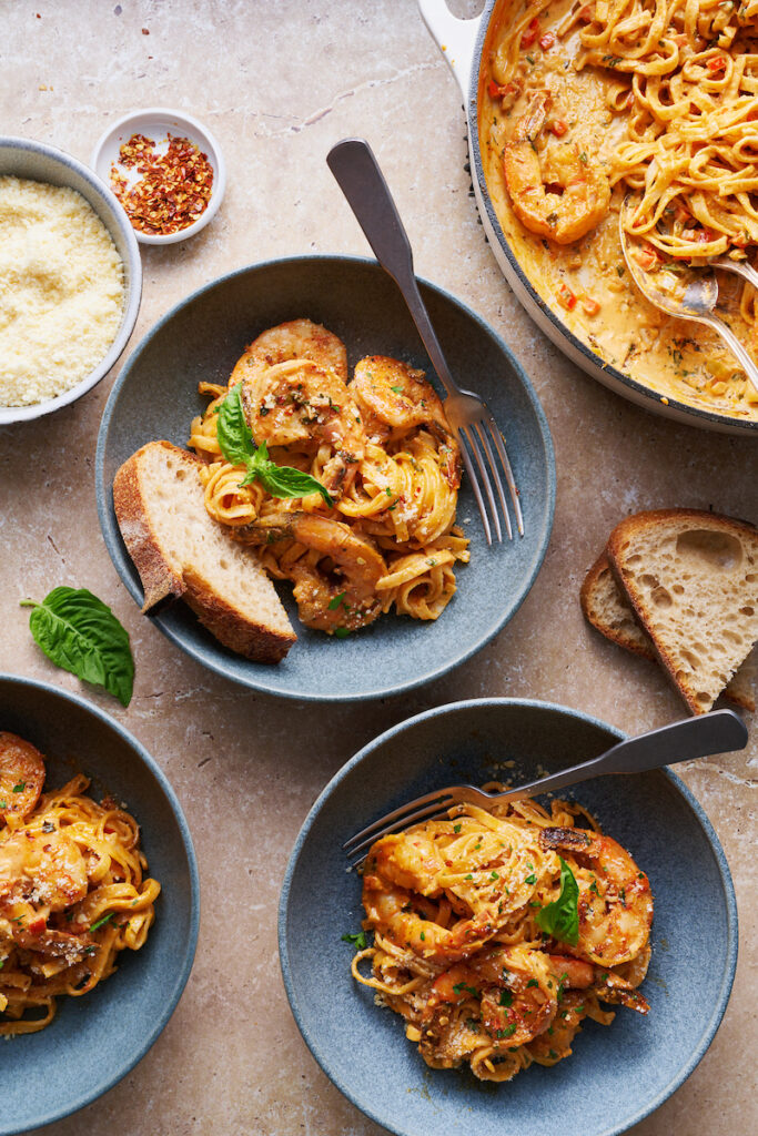 Bowls of creamy cajun shrimp pasta on a table.