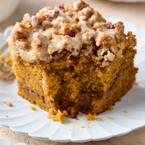 Slice of pumpkin coffee cake with a bite taken out of it.