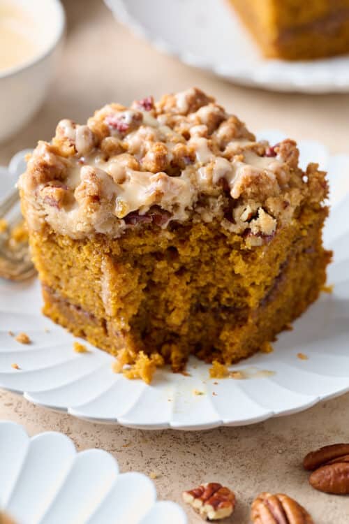 Slice of pumpkin coffee cake with a bite taken out of it.