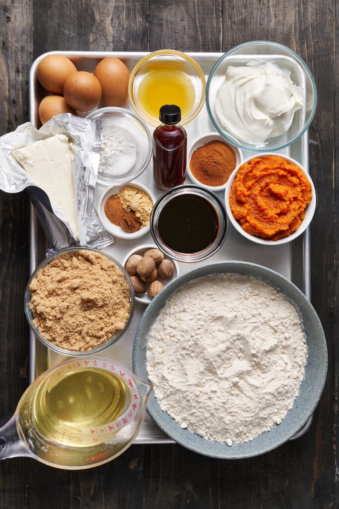 Ingredients on a baking tray for pumpkin cake recipe.