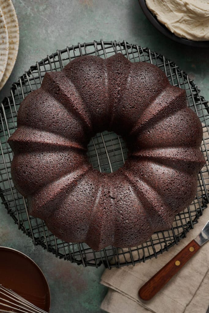 Guinness chocolate cake on a green table, ready to be covered in frosting.