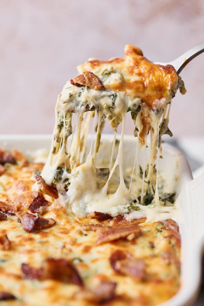 Hot Spinach Artichoke Dip gooey from the baking dish. 
