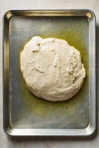 Homemade pizza dough in pizza pan.