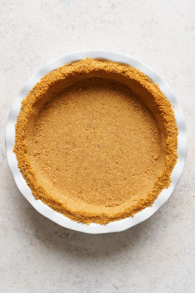 Graham cracker crust for key lime pie in baking dish.