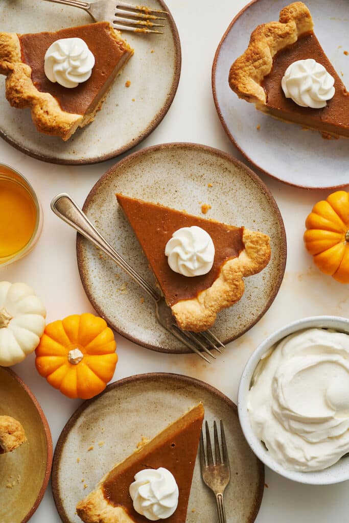 Slices of bourbon pumpkin pie on a large table.