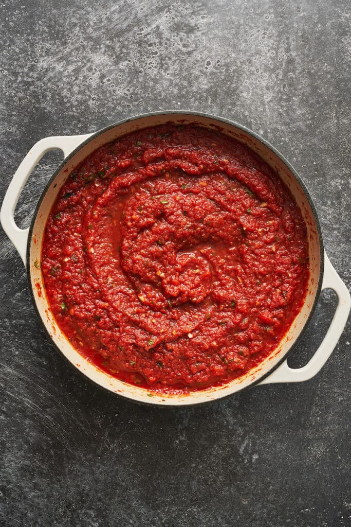 Marinara sauce in a white pot.