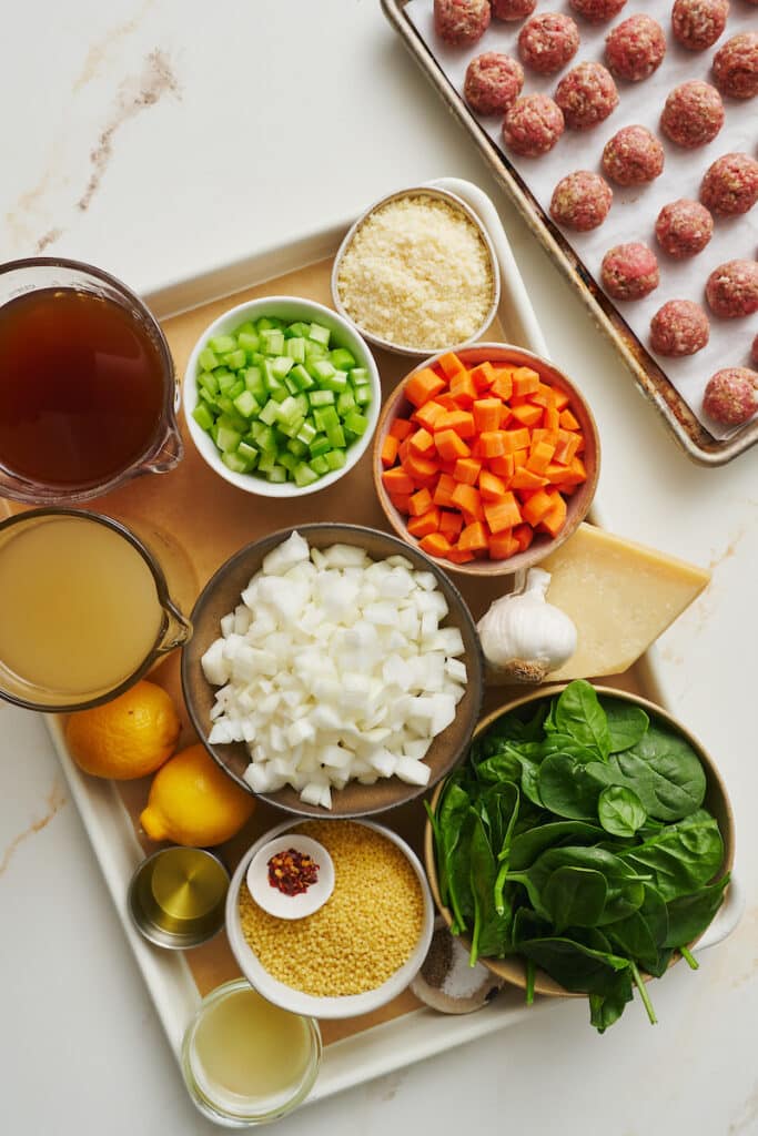 Ingredients on a baking tray for Italian wedding soup. 