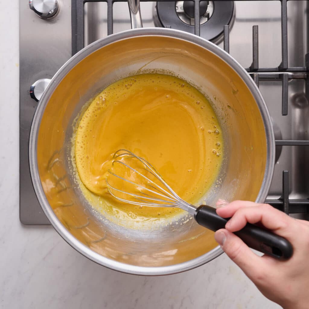 Egg yolks, sugar, and amaretto in double boiler.