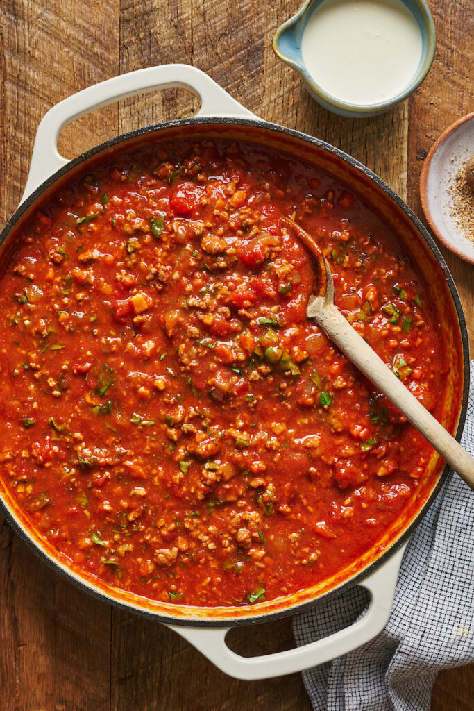 A large pot of bolognese sauce with ground beef and pork.