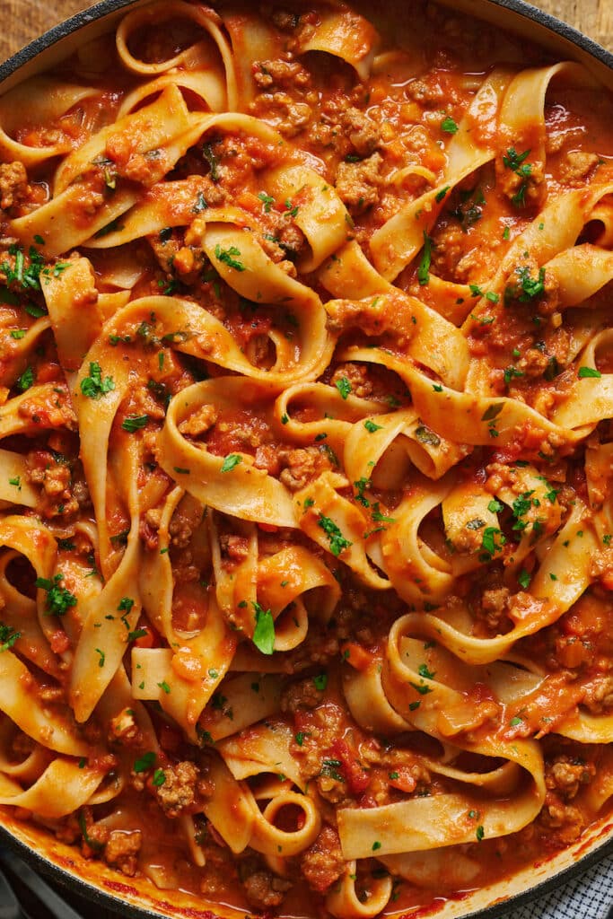 My favorite bolognese recipe is a rich tomato sauce made up of pancetta, ground beef, and Italian sausage. Use this meat sauce in your favorite lasagna, baked ziti, or stuffed shells recipe. Or use this versatile pasta sauce recipe on spaghetti, rigatoni, or tagliatelle. Delicious with a side of garlic knots and a simple salad.