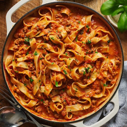 A large pot of bolognese sauce tossed with pasta.