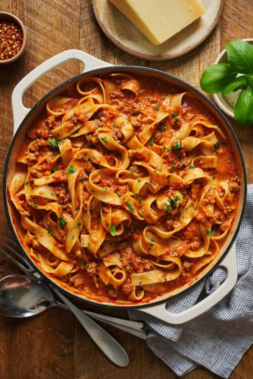 A large pot of bolognese sauce tossed with pasta.