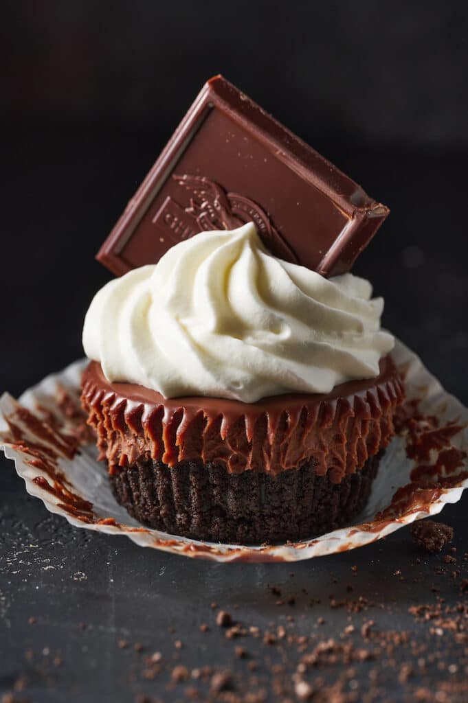 Mini chocolate pie with whipped cream and a chocolate square.