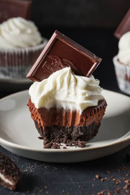 Mini chocolate pie with whipped cream and a chocolate square.