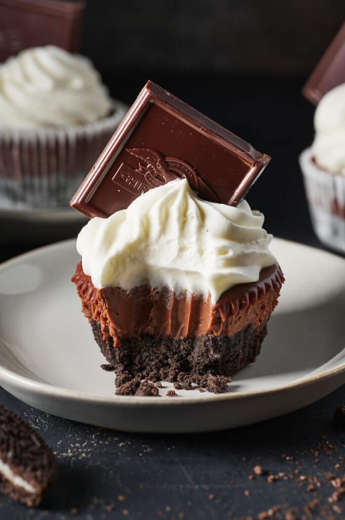 Mini chocolate pie with whipped cream and a chocolate square.