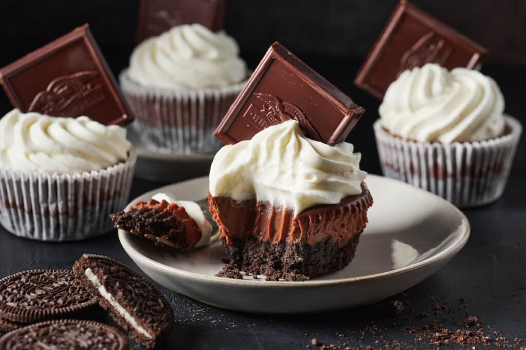 Mini chocolate pie with whipped cream and a chocolate square.