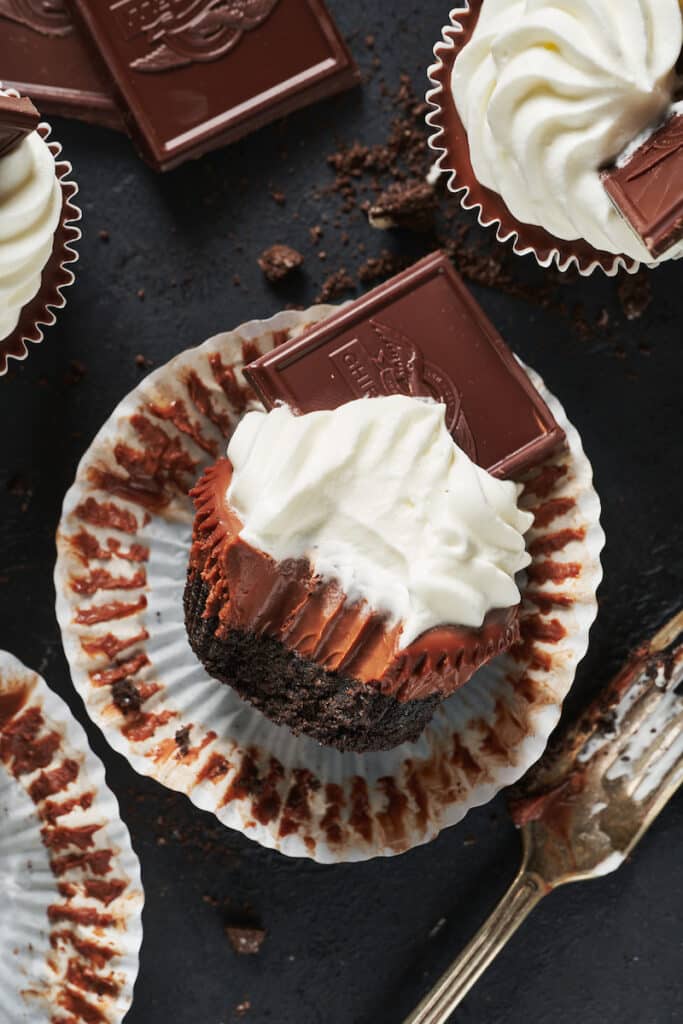 Mini chocolate pie with whipped cream and a chocolate square.