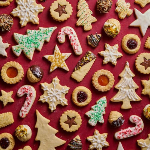 Christmas cookies cut out and decorated with red and green sprinkles.