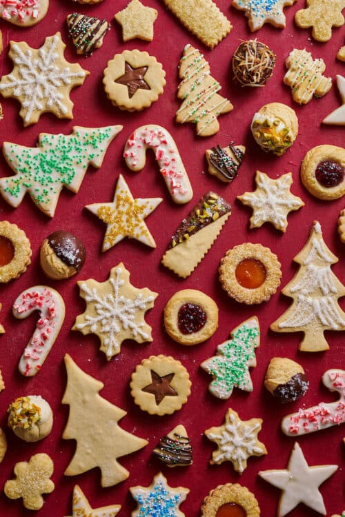 Christmas cookies cut out and decorated with red and green sprinkles.