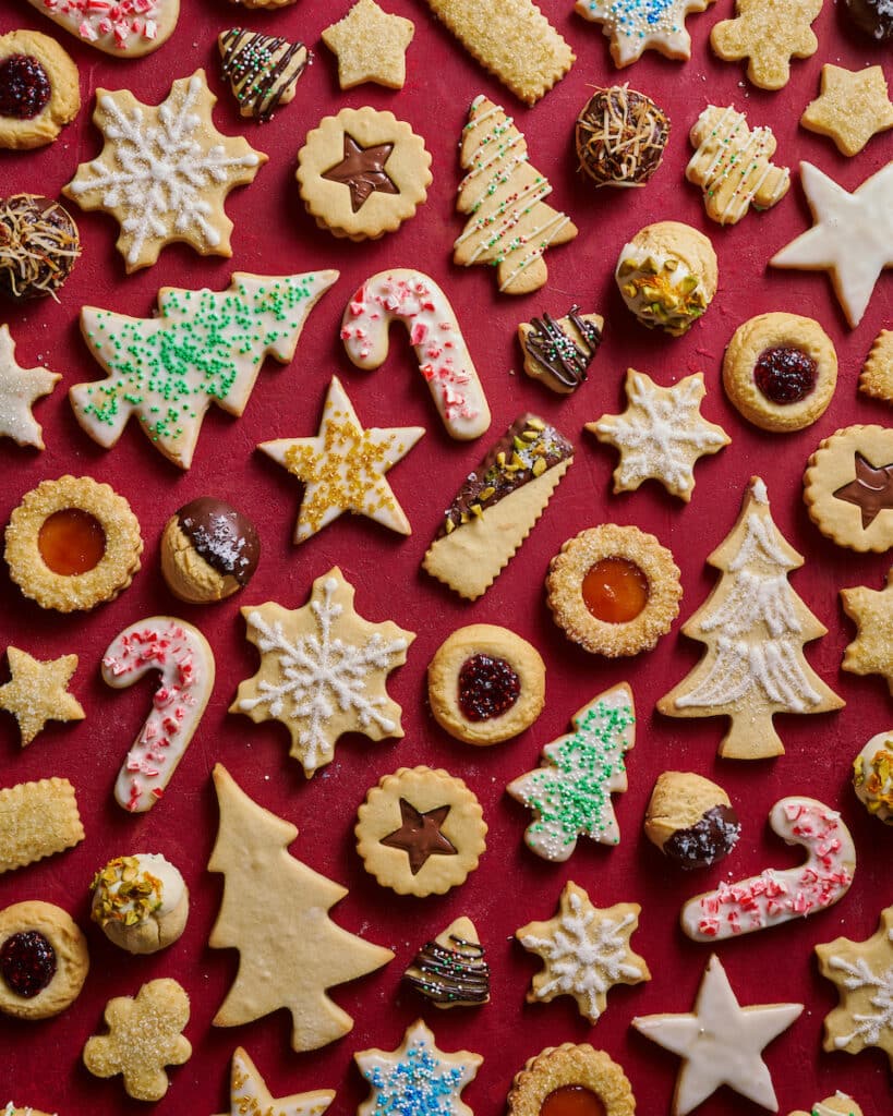 Christmas cookies cut out and decorated with red and green sprinkles. 