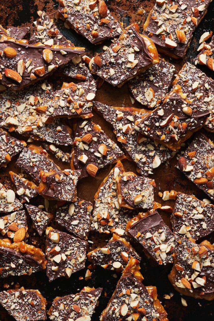 Tray of butter toffee covered in chocolate and almonds.