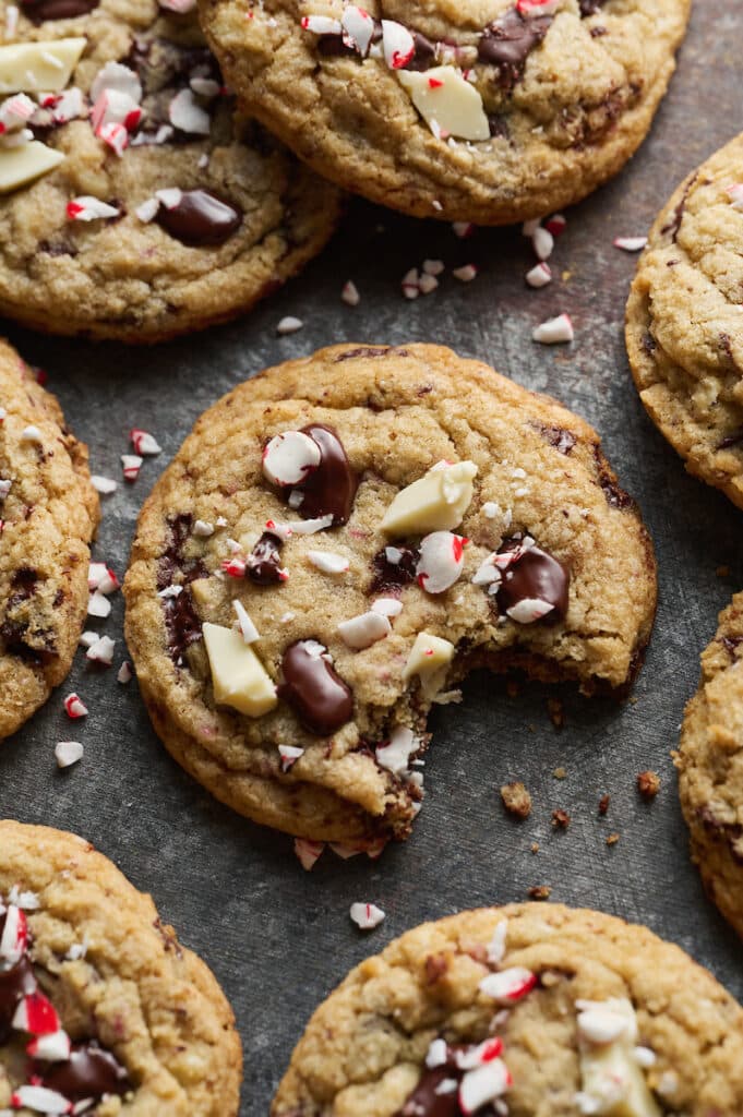 Candy cane cookies with a bite taken out.