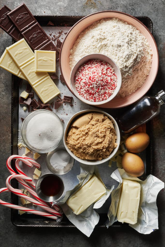 Ingredients for candy cane cookies on a baking sheet.