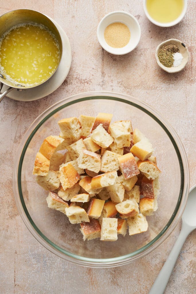 Cubes of bread in a bowl to get tossed with olive oil for homemade croutons.