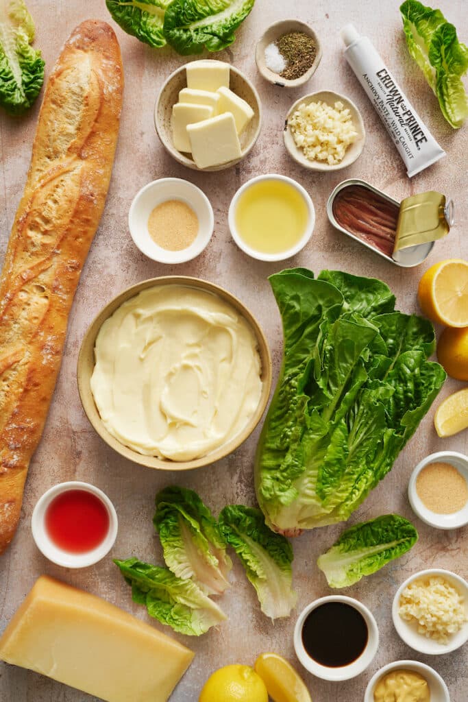 Ingredients for a Caesar salad on table.