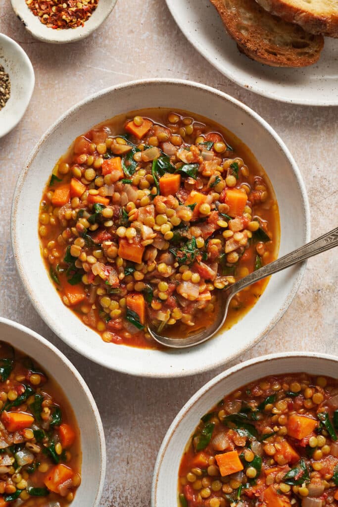 White bowls with lentil soup inside.